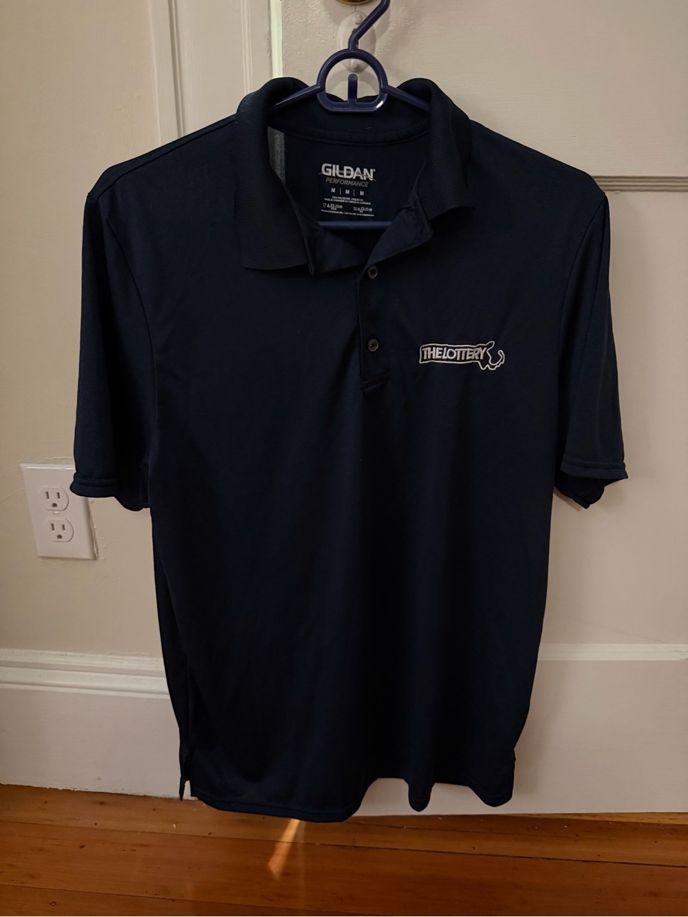 Gildan Performance Navy Polo Shirt with The Lottery Logo